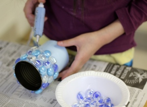 Applying glass marbles with glue gun.