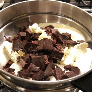 In a double boiler, melt chocolate chunks and butter.