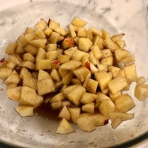 Pour liquid cinnamon/sugar mixture over chopped apples.
